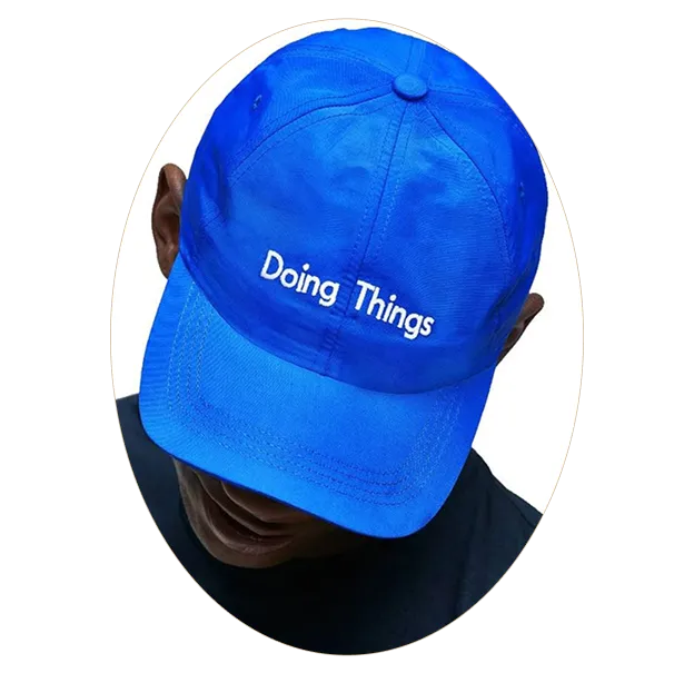 A blue hat with the words doing things printed on it.